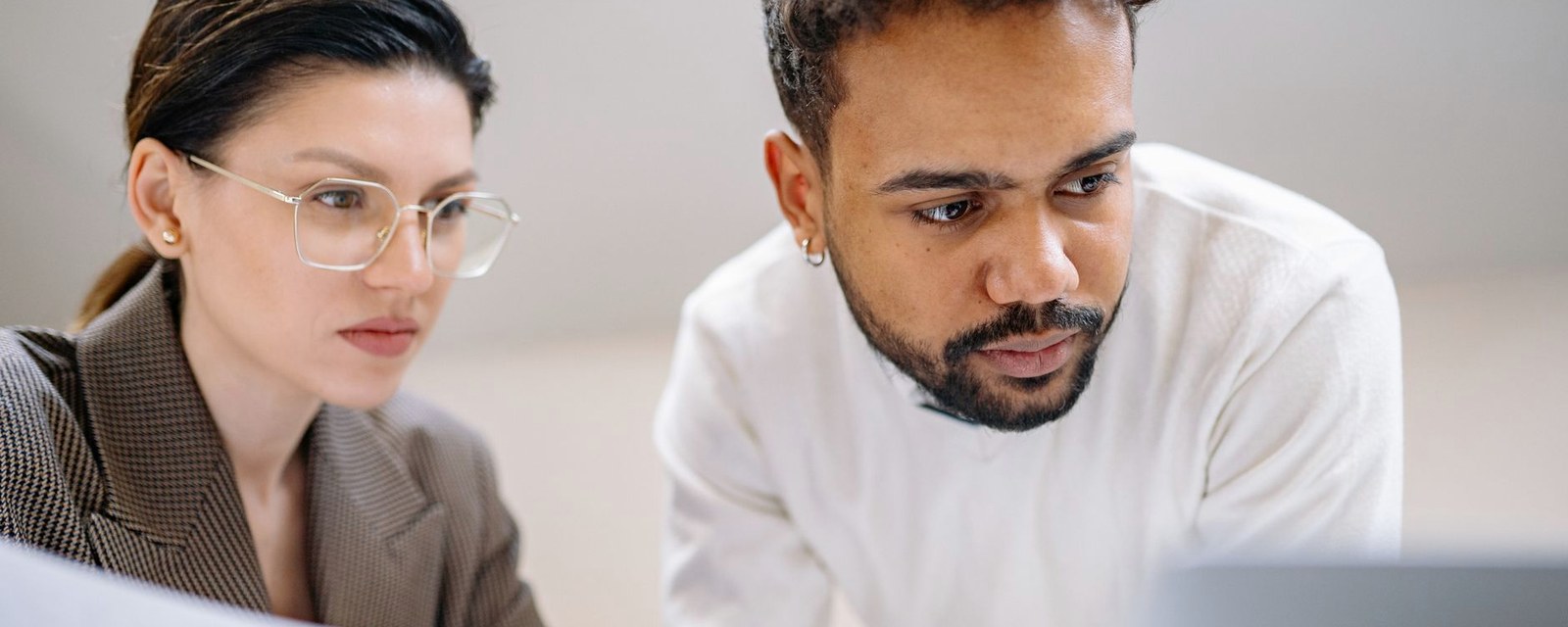 Two colleagues reviewing a document together at a laptop
